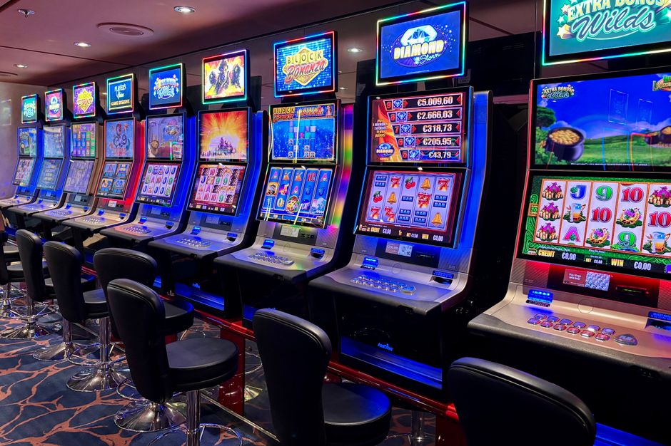 Bright casino slot machines with colorful displays and no people present.